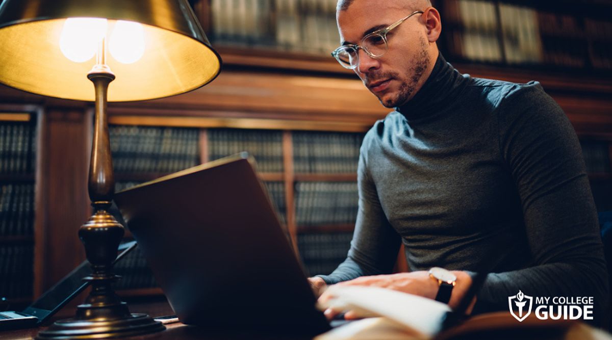 A man choosing an online law school, illustrating the decision-making process for prospective law students.