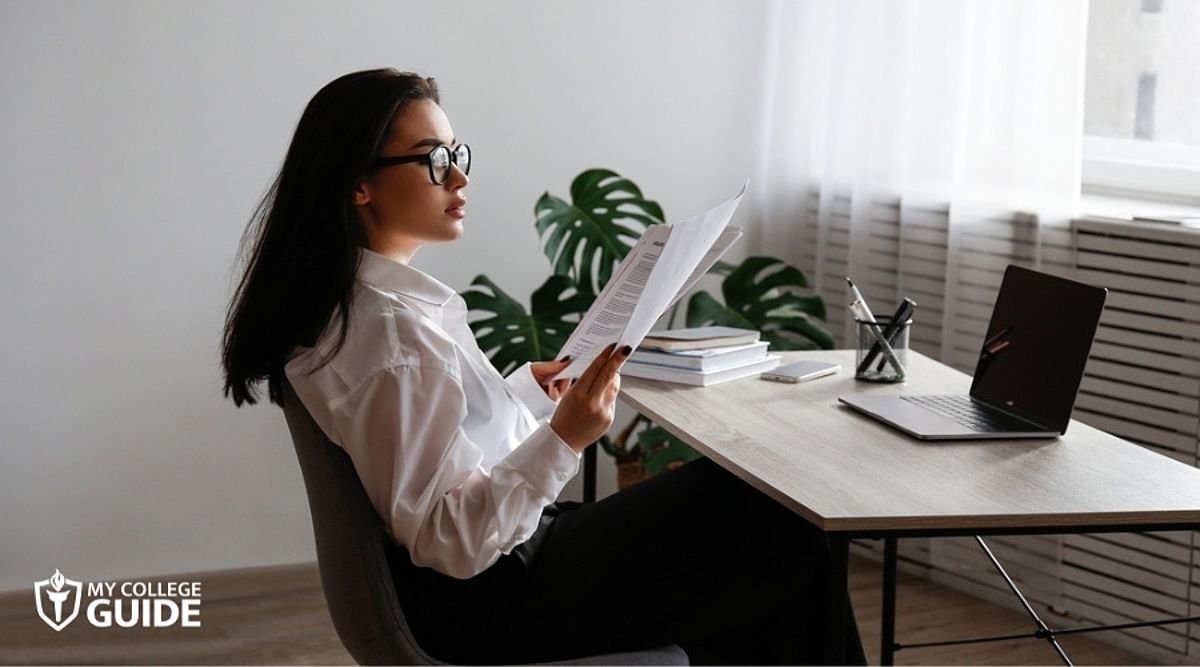 A woman preparing her requirements for an online law degree, emphasizing the admissions process.