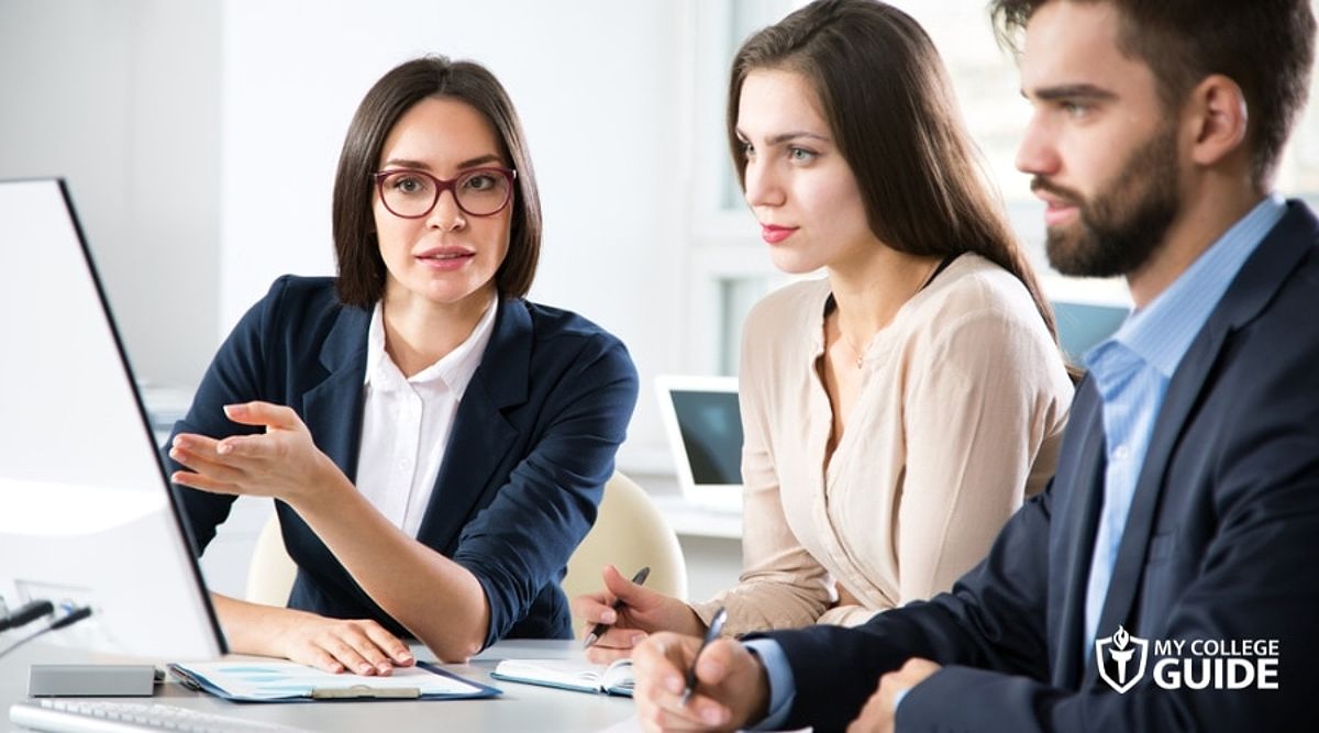 Lawyers collaborating in an office setting, indicating teamwork in the legal profession.